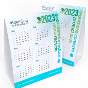 A seed paper tent card calender with eco-themed words on it