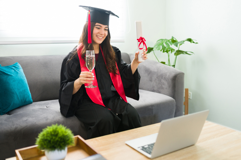 a graduate smiling and holding her diploma for a virtual grad celebration