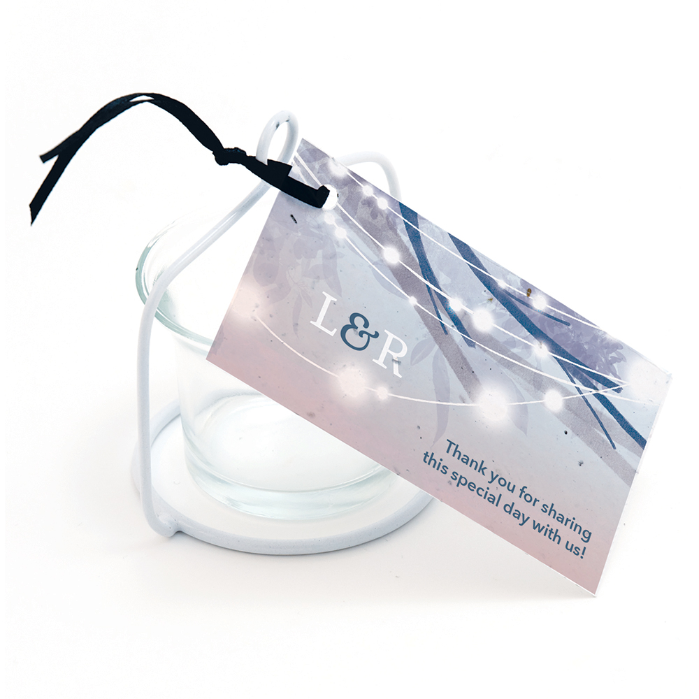A plantable favor tag with an evening style design featuring glowing lights in trees.
