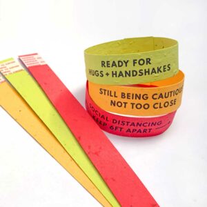 Color-coded social cues wristbands made with seed paper shown on white background.