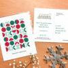 A seed paper postcard with a geometric pattern design in festive colors.