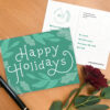 Seed paper postcard with greenery design and Happy Holidays typography