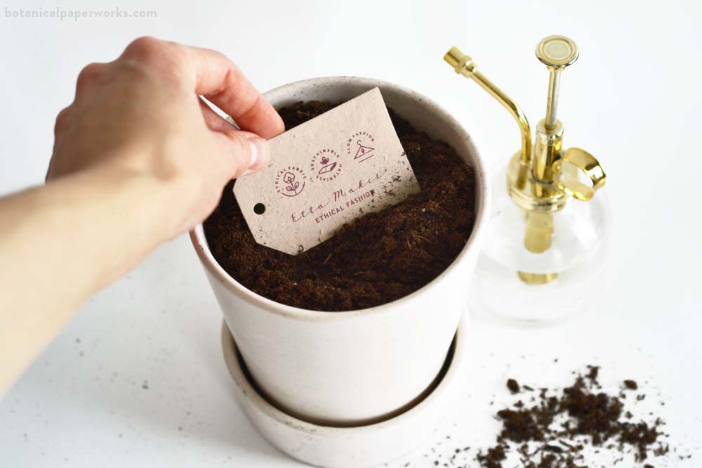 Planting Botanical PaperWorks seed paper product tags in soil.