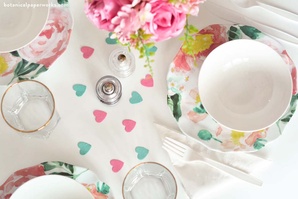 Seed paper heart confetti in aqua and hot pink from Botanical PaperWorks sprinkled onto a tablescape