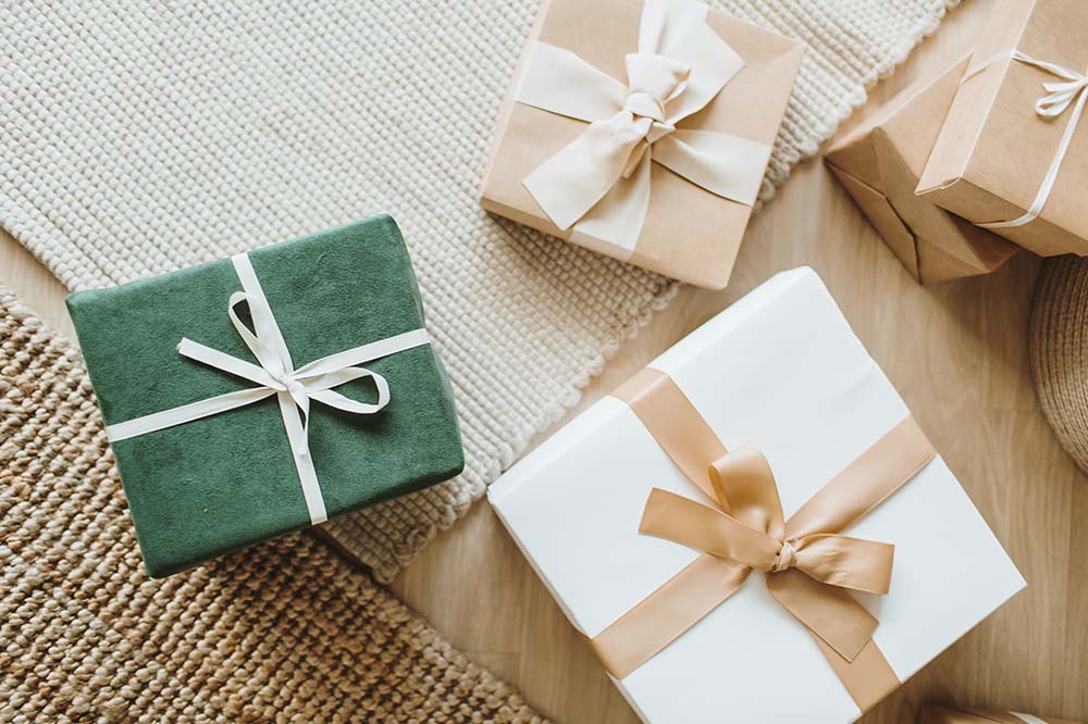 a set of gifts wrapped in green and beige