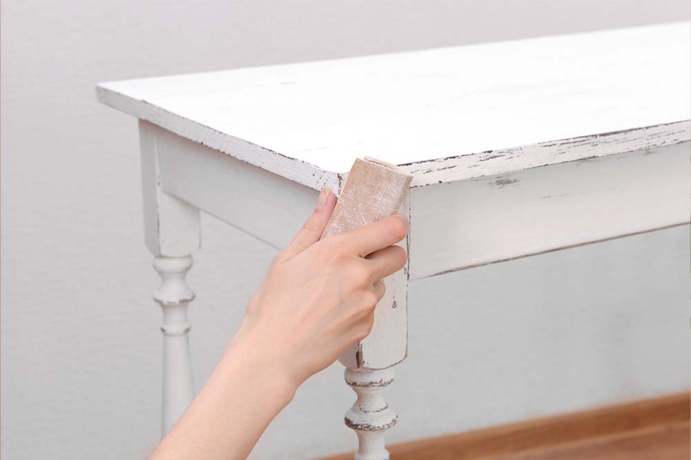 a person preparing their table for repainting 