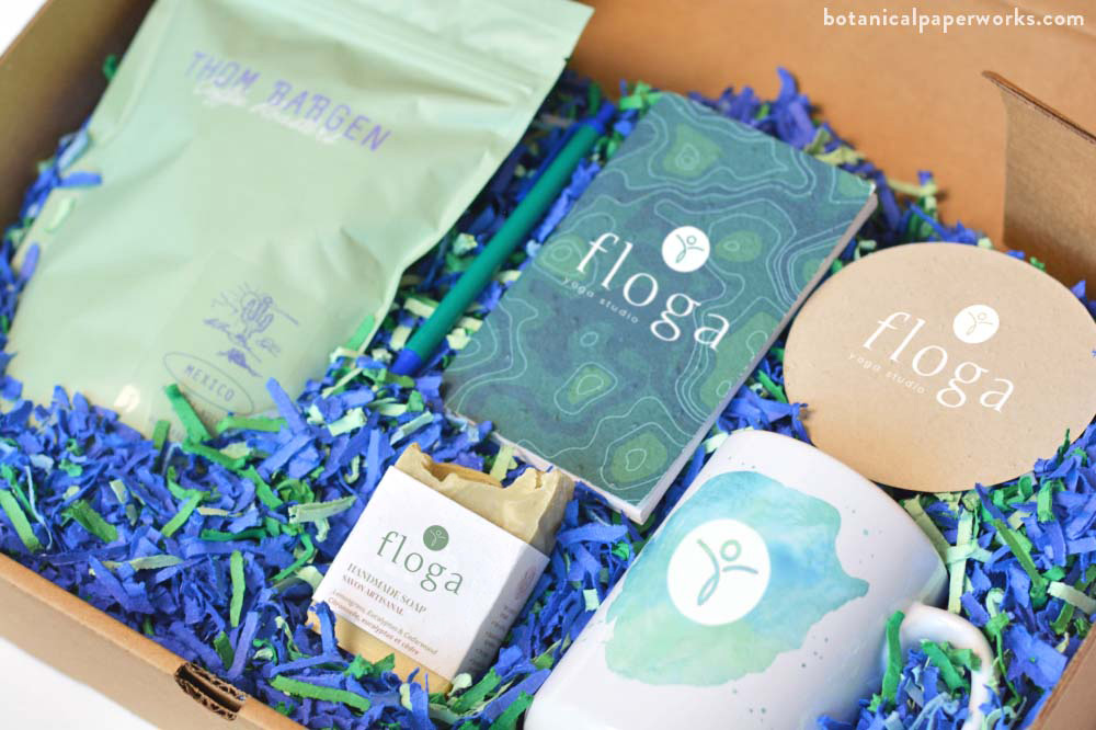 Promotional Work-From-Home Kit with seed paper box filler, seed paper notebook, handmade soap and seed paper coaster.