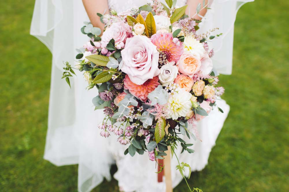 bridal bouquet with roses, dahlias, peonies, and greenery