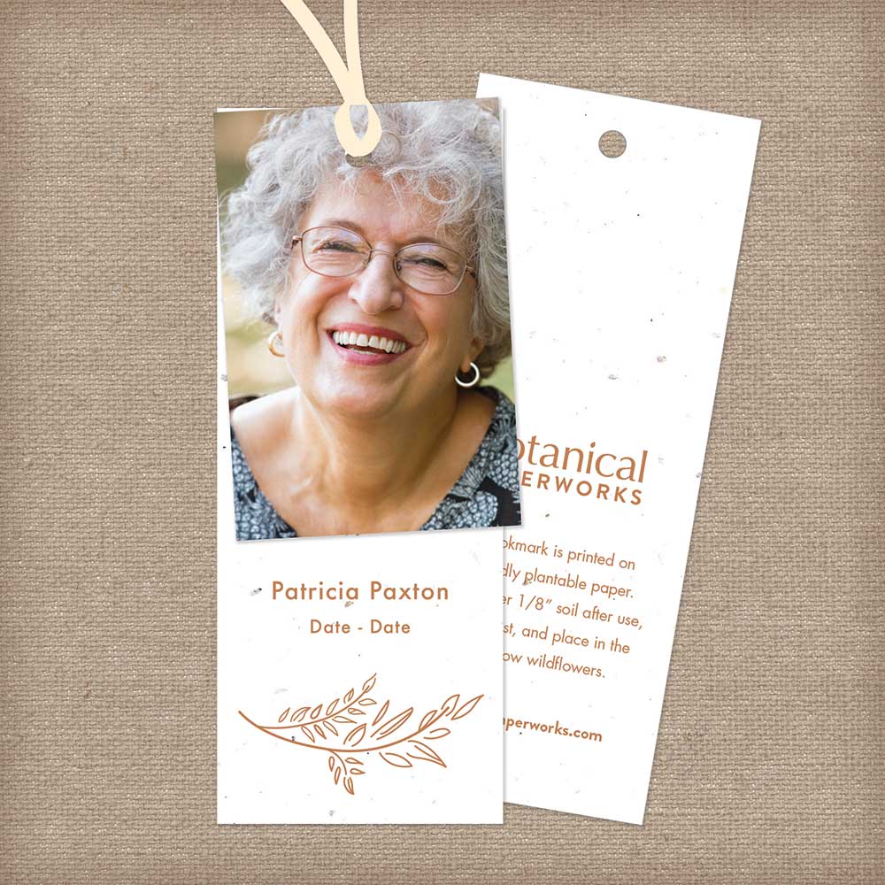 A seed paper memorial bookmark featuring a custom photo attached with ribbon