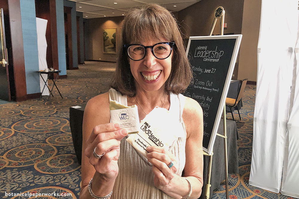 Ron Wright from The Book Company holding a custom-branded handmade soap promotion from Botanical PaperWorks at PPAI Women's Leadership Conference 2022