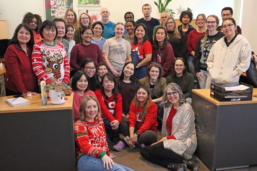 Heidi Reimer-Epp, CEO of Botanical PaperWorks with team members in a group holiday photo