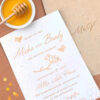 Seed paper wedding invitations with two honey bees and a wildflower