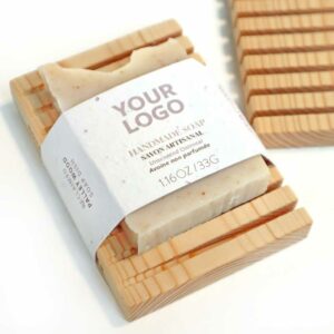 Upcycled wood soap dish wrapped with handmade natural soap. Custom-branded with a logo.