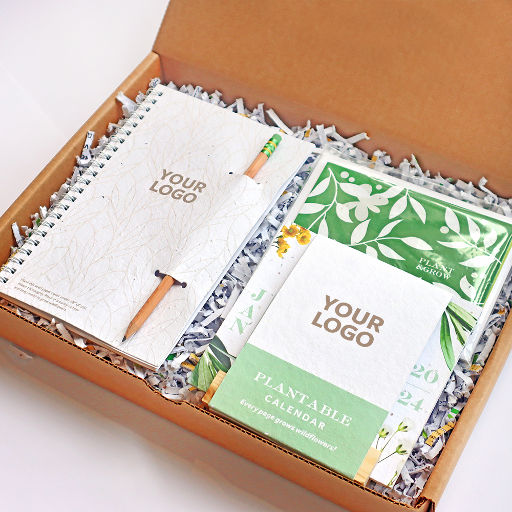 An eco-frienldy promotional gift set including three plantable seed paper workspace items; plantable journal with eco-friendly pencil, eco calendar, and seed card set.