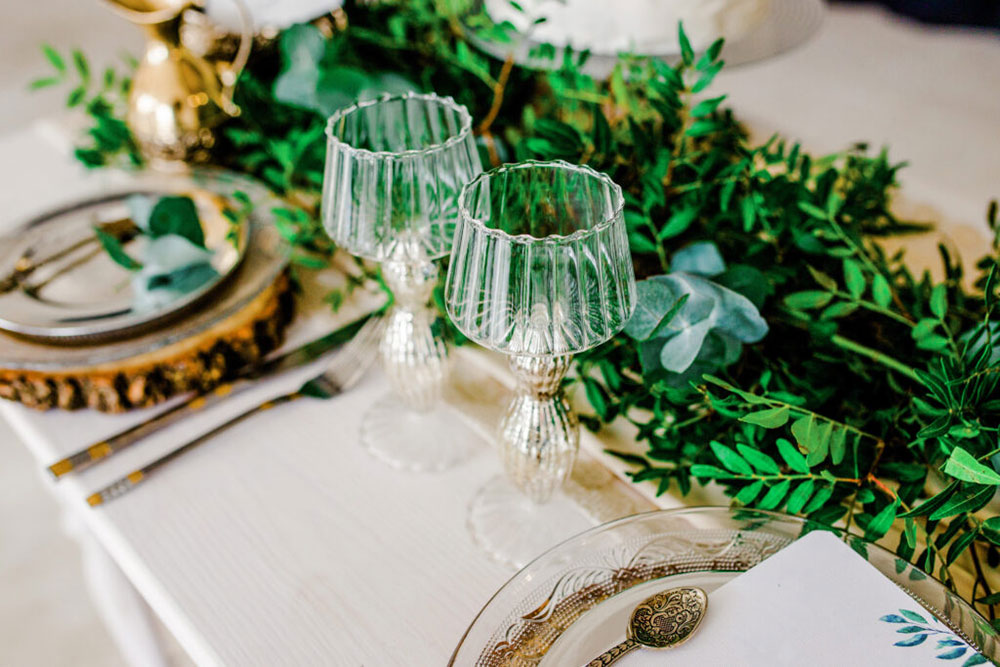 Woodsy tablescape showing two settings with crystal goblets