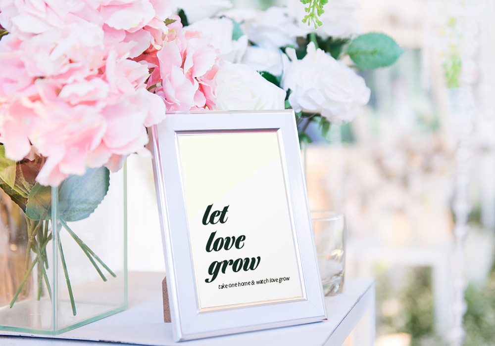 let love grow sign framed on a table with 2 vases of flowers