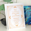 Seed paper wedding invitations with white envelopes featuring a gold 1920s-inspired design that has leaf embellishments