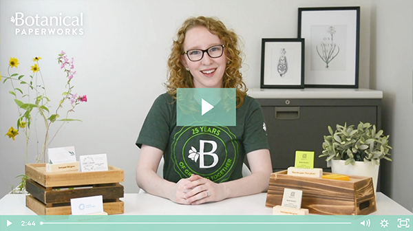 Rachel from Botanical PaperWorks with a play button over top. A thumbnail to play a video about seed paper business cards.