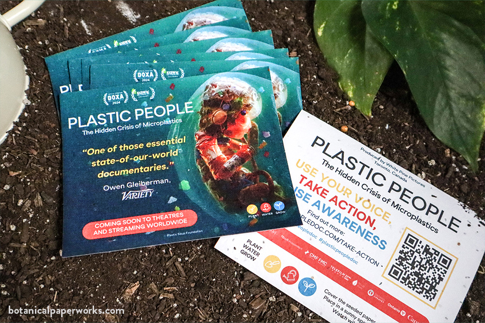 Plastic People documentary seed panel cards lying on soil.