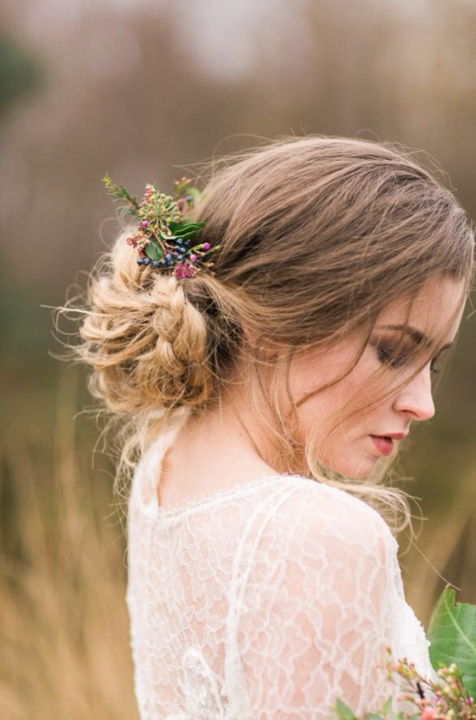 We love the look of this brides braided updo with tiny pieces of wildflowers crowning around the braids.